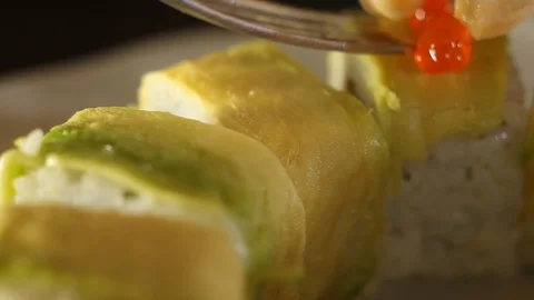 The process of decorating rolls with red caviar.Close-up of sushi rolls Stock Footage 119861939