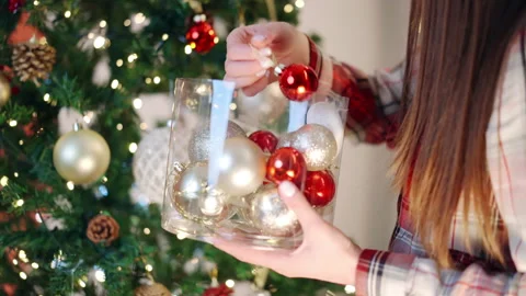 Process of decorating spruce tree with festive ornaments and blinking light Stock Footage 255826066