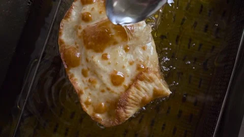The process of deep-frying chebureks in boiling oil. 스톡 동영상 189332780