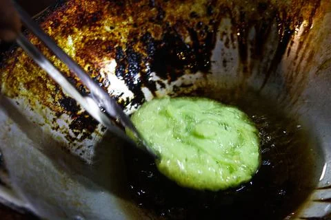 Process of Deep Frying Green Kue Cucur Pancake in Boiling Oil Close Up Fotos Stock