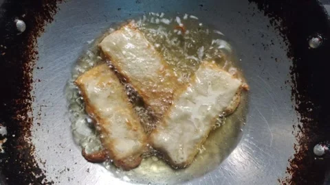 The Process of Deep-frying Tempeh Stock Footage 319723073
