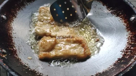 The Process of Deep-frying Tempeh Stock Footage 319723086