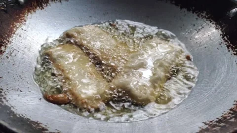 The Process of Deep-frying Tempeh Stock Footage 319723159