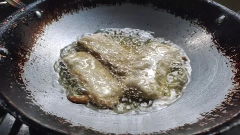 The Process of Deep-frying Tempeh Stock Footage 319723161