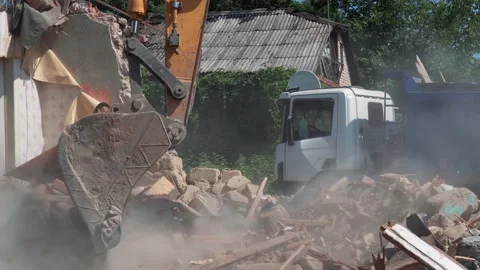 Process of demolition of old building dismantling. Excavator breaks old house Stock Footage 169056645