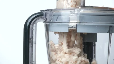 The process of dicing cooked chicken fillet in a food processor Stock Footage 327647314