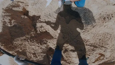 The process of digging out sand with a shovel at the landfill tests Stock Footage 201034070