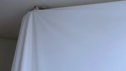 Process of dismantling of stretch suspended ceiling in flat, closeup view. Stock Footage 123346545