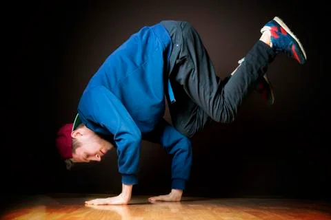 The process of doing freeze by young dancer in dark studio Stock Photos