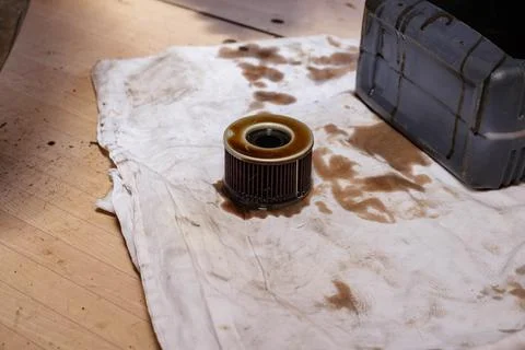 The process of draining oil from a motorcycle engine. Engine oil upgrade. Stock Photos