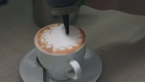 The process of drawing faces on coffee foam Stock Footage 73073278