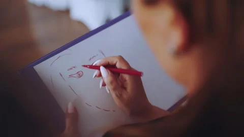 The process of drawing a portrait with a marker on a piece of paper Stock Footage 168202840
