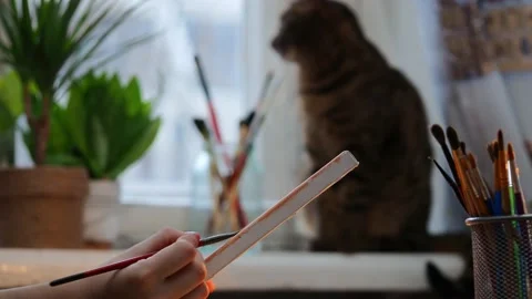 The process of drawing . A young girl draws while sitting at a table. Stock Footage 229376511