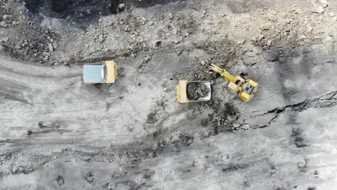 The process of dredging and loading soil into trucks to make hauling roads .. Stock Footage 314271115