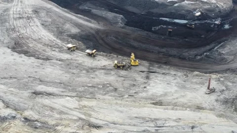 The process of dredging and loading soil into trucks to make hauling roads .. Stock Footage 314271263