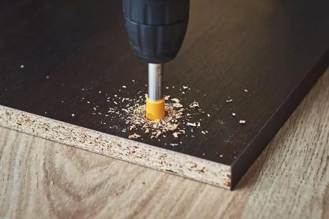 Process of drillig wood with a drill bit close up Stock Photos