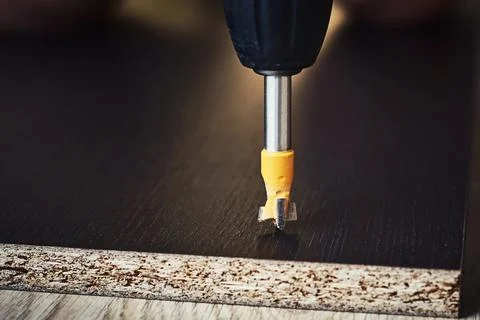 Process of drillig wood with a drill bit close up Stock Photos