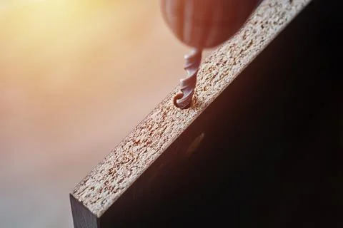 Process of drillig wood with a drill bit close up Stock Photos