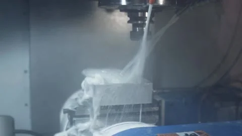 Process of drilling metal parts on an automatic milling machine with coolant. Stock Footage 97381232