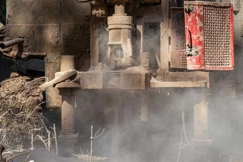 The process of drilling a well with a small-depth drilling rig. There is a lo Stock Photos