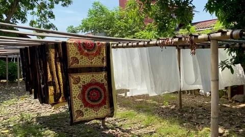 The process of drying batik cloth during the day. Stock Footage 249158185