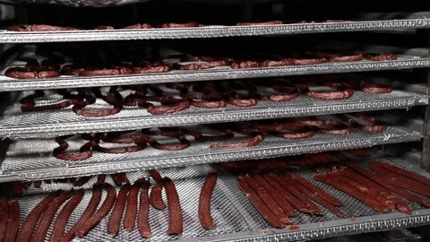 Process of drying meat products on hangers. Hunting sausages, sticks of dried sa Stock Footage 118976339