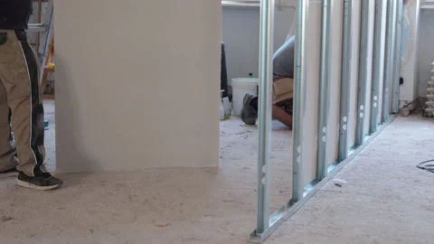 Process of drywalls installation on horizontal and vertical metal profiles on Stock-Footage 134646743