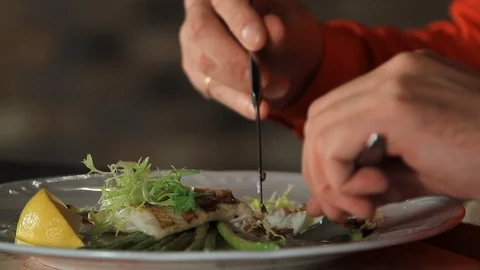 The process of eating blanched asparagus and grilled fillet of pike perch Video stock 116779040