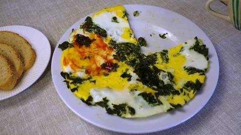 The process of eating scrambled eggs with spinach. Stock Footage 100875520