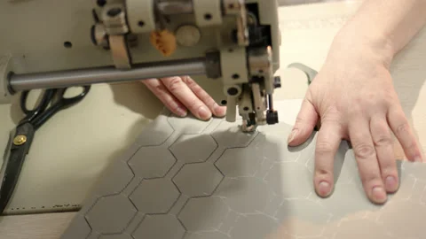 Process of embroidering diamond pattern on cowhide in atelier for helicopter or Stock Footage 175791832