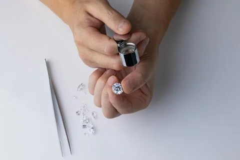 Process of evaluating diamond at diamond dealers workplace. Stock Photos