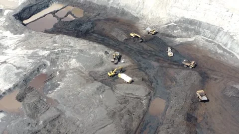 The process of an excavator loading coal onto a truck to be taken to the pr.. Stock Footage 314273240