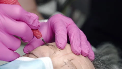 Process of eyebrows tattoo procedure in beauty salon, tattoo machine concept Stock-Footage 162664992