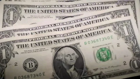 The process of falling one dollar bills like dominoes and bundles of money cl Stock Footage 153241292