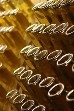Process of fermentation of cider in bottles in special wooden racks Stock Photos