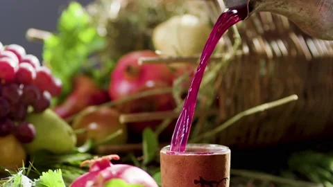 Process of filling clay cup with wine or red drink from carafe. Pomegranate  Video stock 199028924