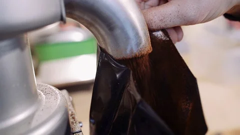 The process of filling the ground coffee into the package. Coffee production Video stock 122148242