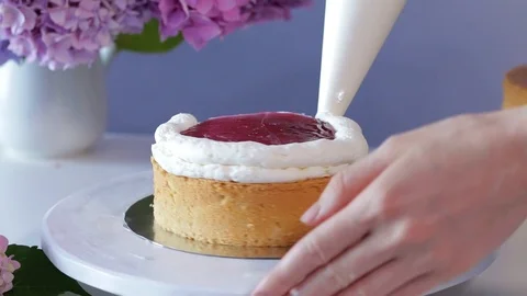 The process of filling layer of the cake with cream and jelly coating Stock Footage 102931981