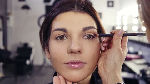 Process of filling the outer corner and crease with purple eyeliner. Beautiful Stock Footage 86596100