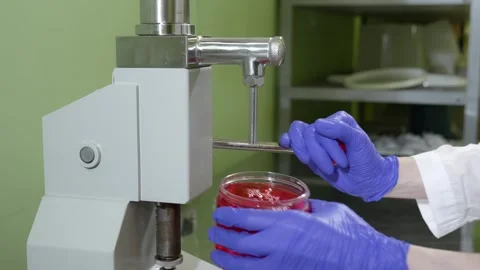 The process of filling red liquid collagen into containers for further sale. Stock Footage 304576717
