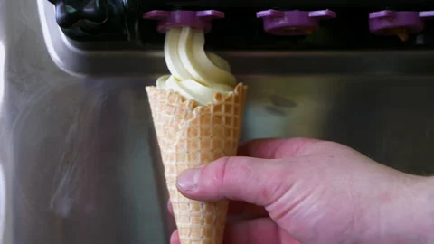 Process of filling waffle cone with ice cream Stock Footage 154274259