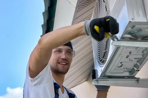 Process of fixing metal brackets to hold the outdoor unit of the air conditioner Stock Photos