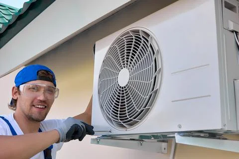 Process of fixing metal brackets to hold the outdoor unit of the air conditioner Stock Photos