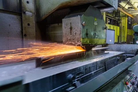 A process of flat surface grinding with a lot of sparks and liquid cooling in Foto stock