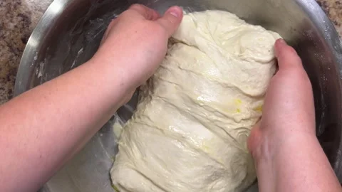 The process of folding and stretching raw yeast dough to make homemade ciabatta. Stock Footage 321145205