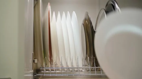 The process of folding white plates into a kitchen drawer, close-up Stock Footage 324698919