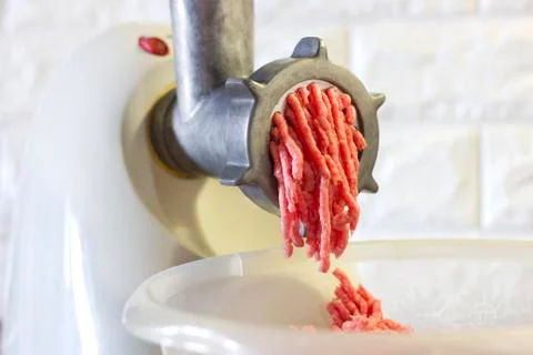 Process of fresh red meat grinding from mincing machine Stock Photos