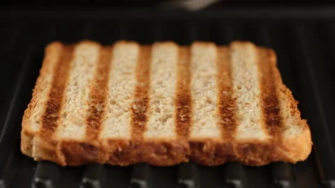 Process fry toast bread on grill. Grilled sandwich bread close up Stock Footage 242587014