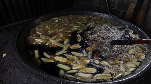 The process of frying banana chips Stock Footage 304847301