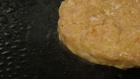 Process of frying burger cutlet in oil, bubbling oil, close-up view Stock Footage 76897685